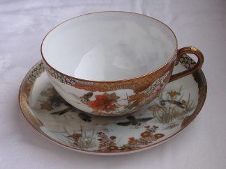 Cup and saucer with birds and flowers marked Oda, 1900-1920