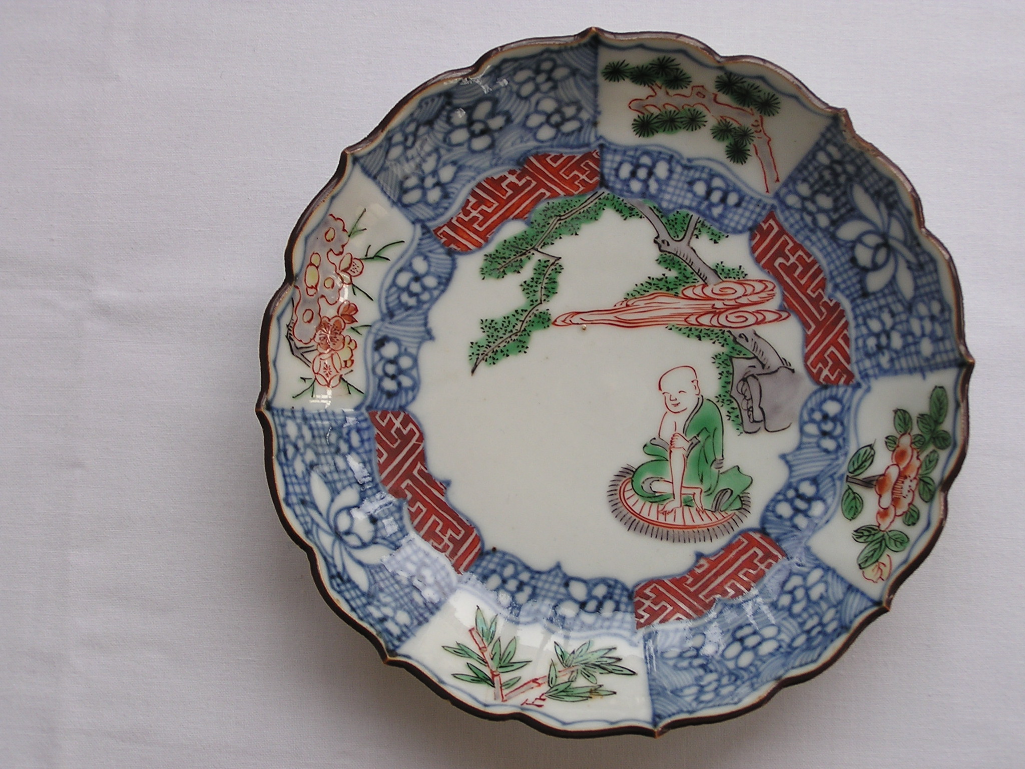 Lobed plate with monk meditating under tree and Chenghua mark, 1690-1730
